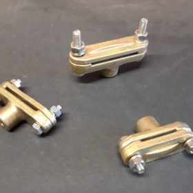 Brass supports for copper busbars