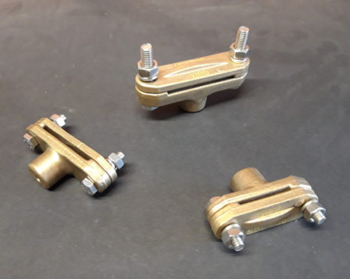 Brass supports for copper busbars